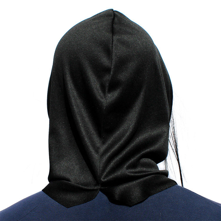 Latex witch mask rear view — black fabric hood drape showing realistic fit and hair placement