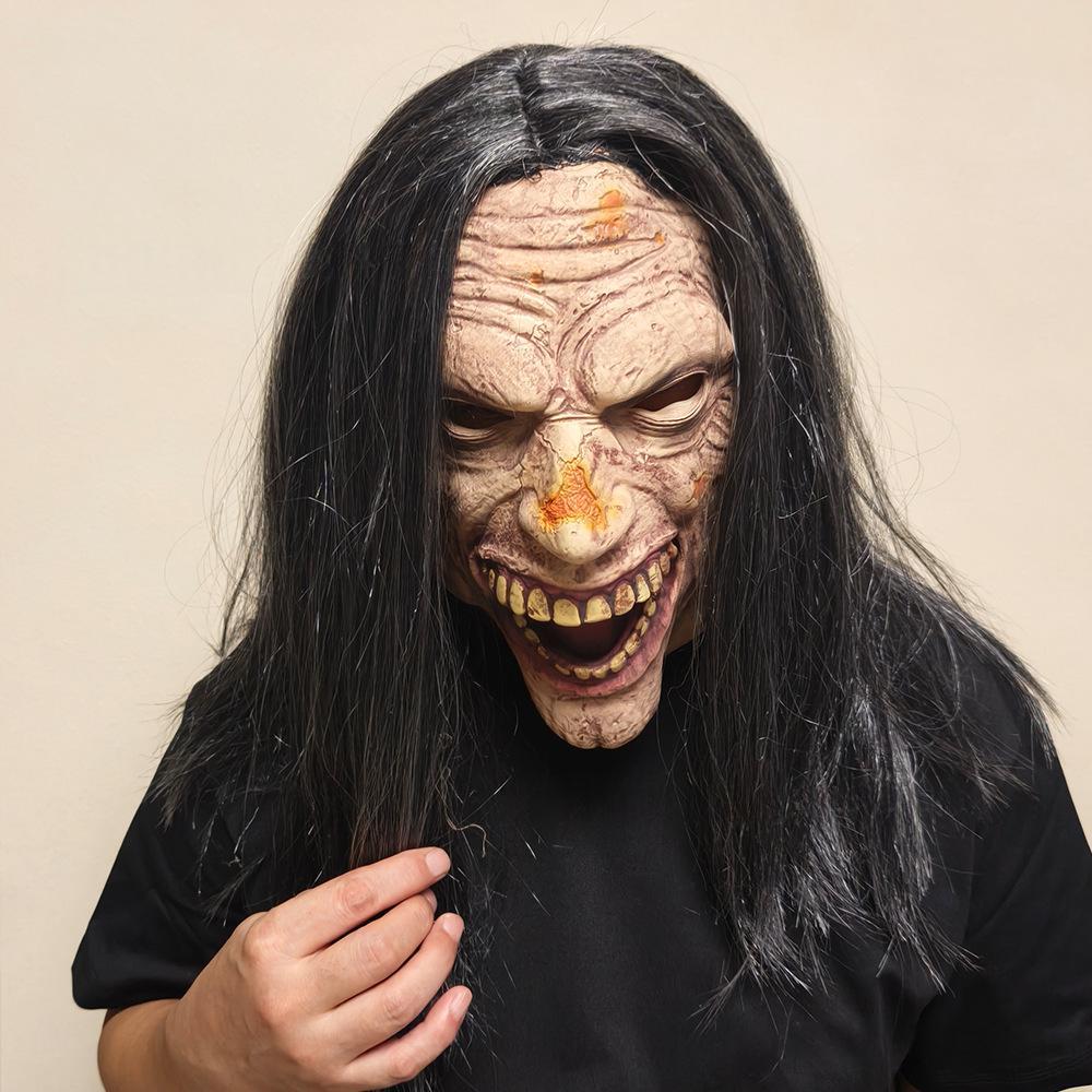 Long Hair Zombie Mask worn — mid-cackle expression, black hair held in hand